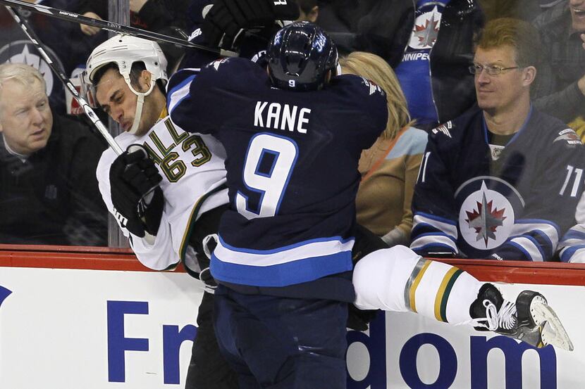 Winnipeg Jets' Evander Kane (9) checks Dallas Stars' Mike Ribeiro (63) into the boards...