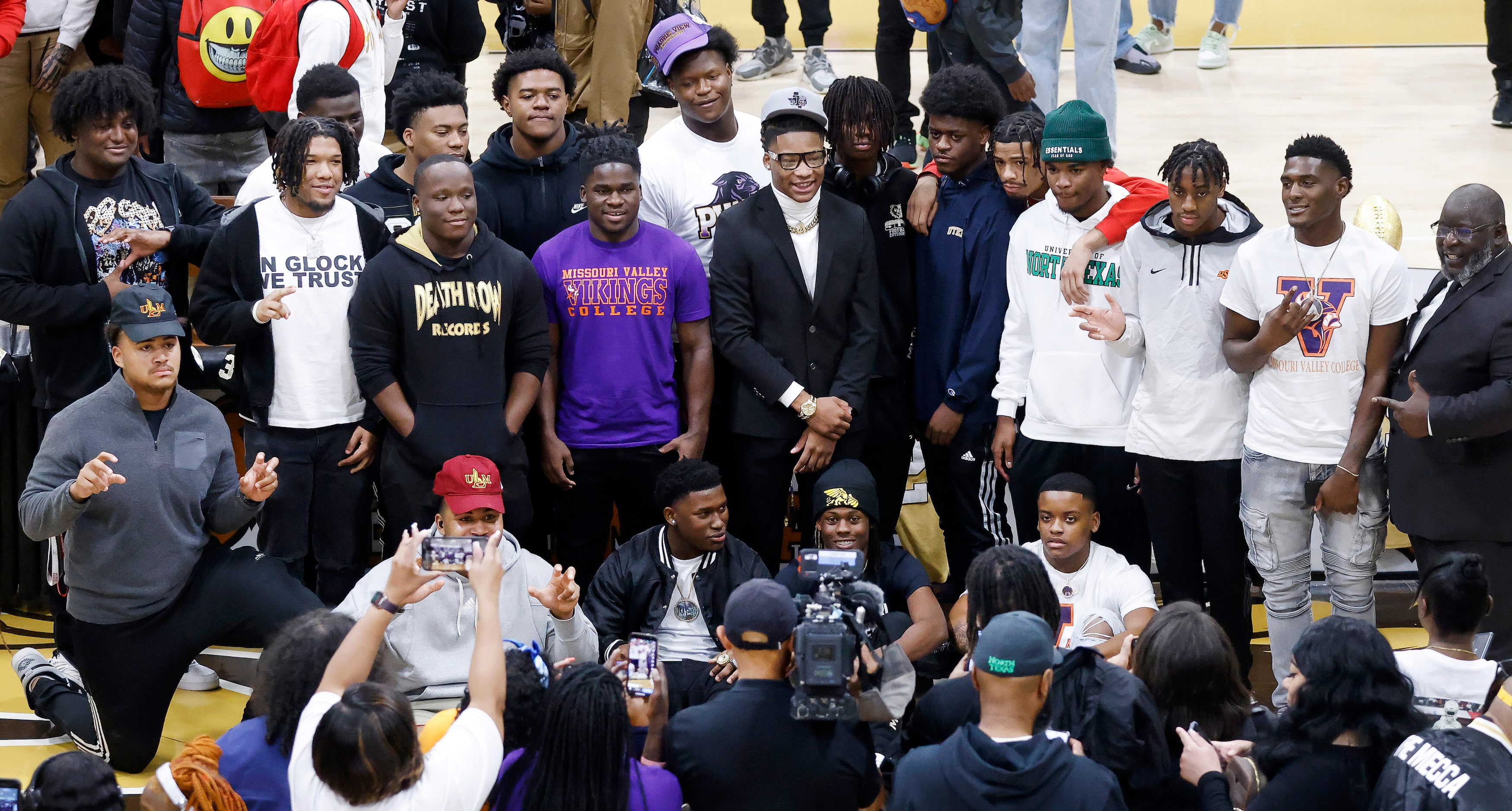 South Oak Cliff football players gathered to pose for photos following the national letter...