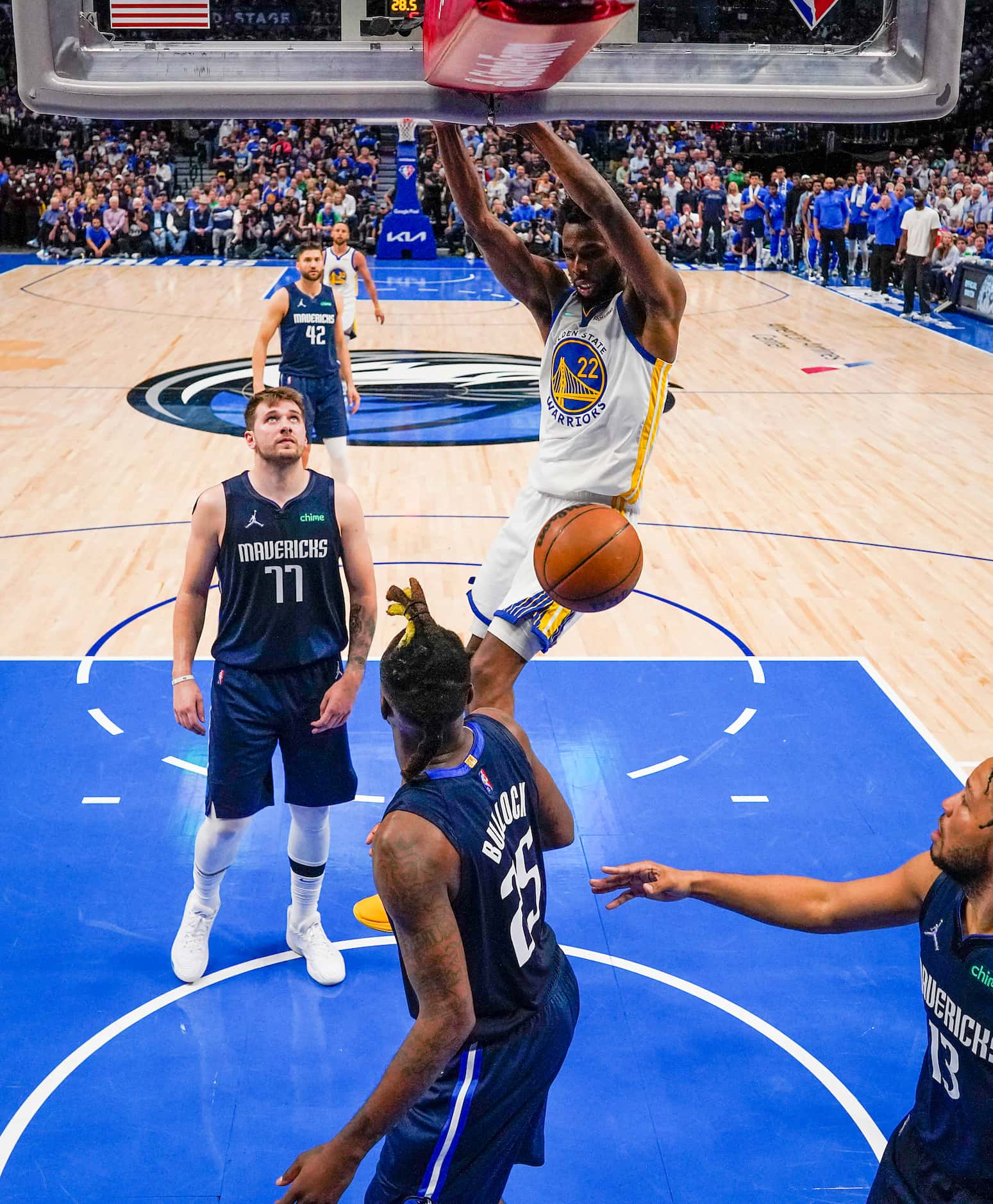 Golden State Warriors forward Andrew Wiggins (22) dunks the ball past Dallas Mavericks guard...