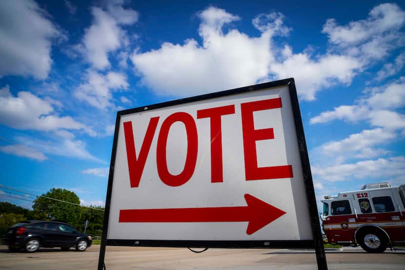 Traffic passes a polling place sign outside a Collin County Early Voting Location at...