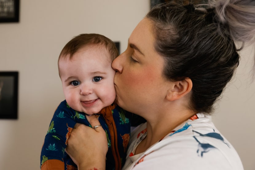 Sarah Brooke kisses her 6-month-old son Solo Sorrells at their home in Foley on Monday, May...