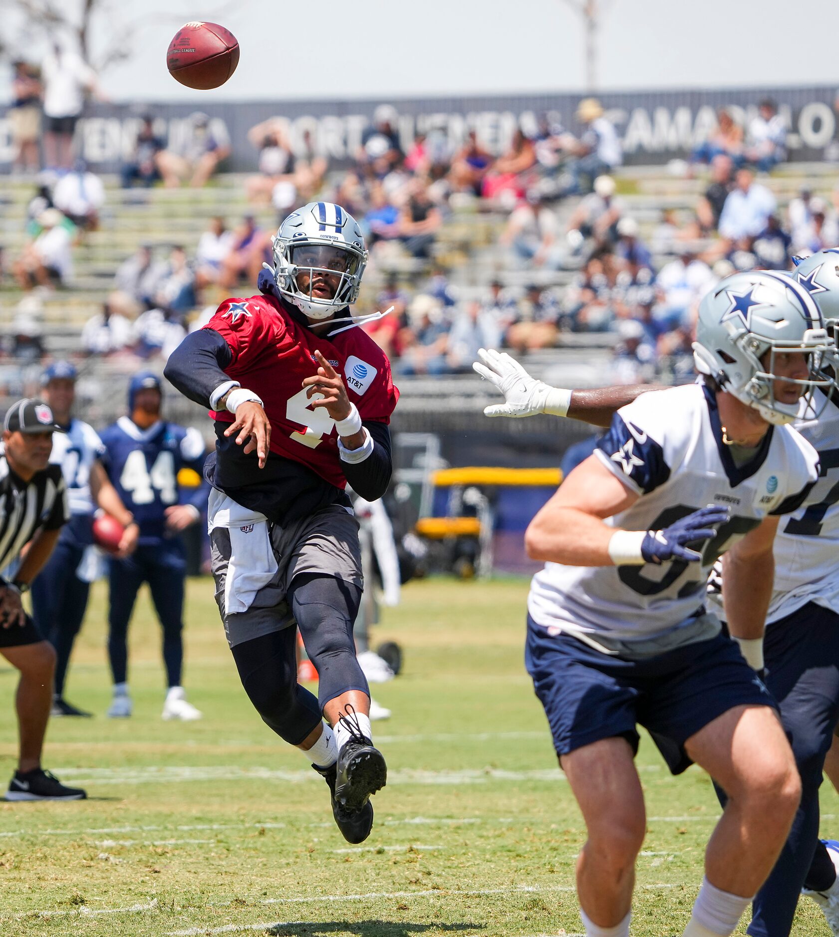 Dallas Cowboys quarterback Dak Prescott (4) throws a pass on the run during a practice at...