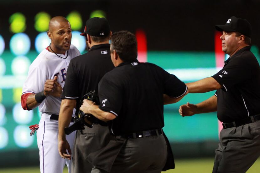 Texas Rangers Alex Rios argues with Umpires after third base umpireAndy Fletcher called Rios...