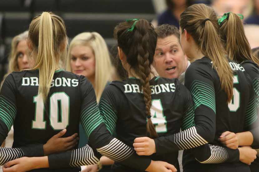 Southlake Carroll coach Ryan Mitchell shares some strategy with his team during a playoff...