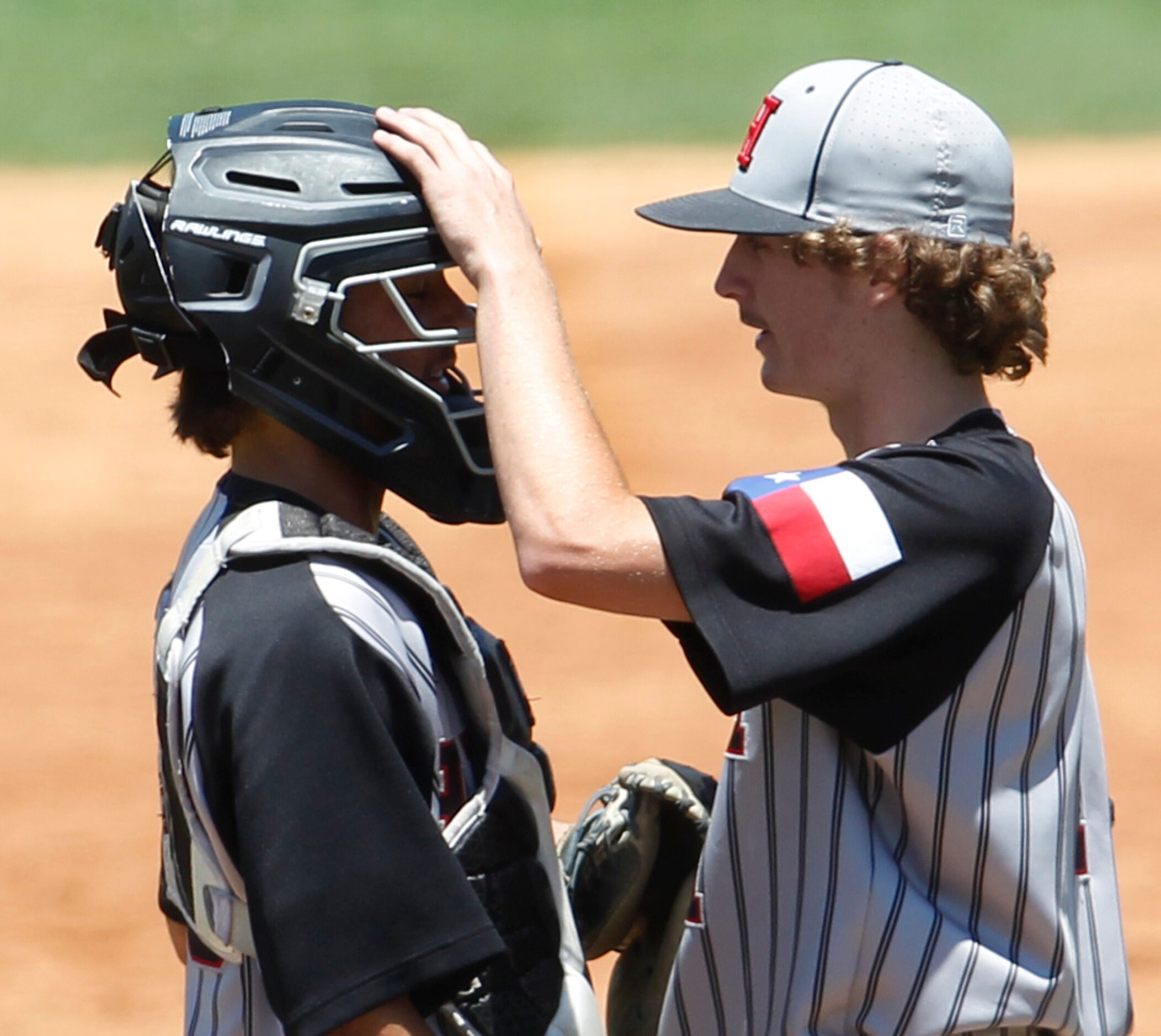 Rockwall Heath pitcher Baylor Baumann (1) right, talks batter strategy with catcher Gage...