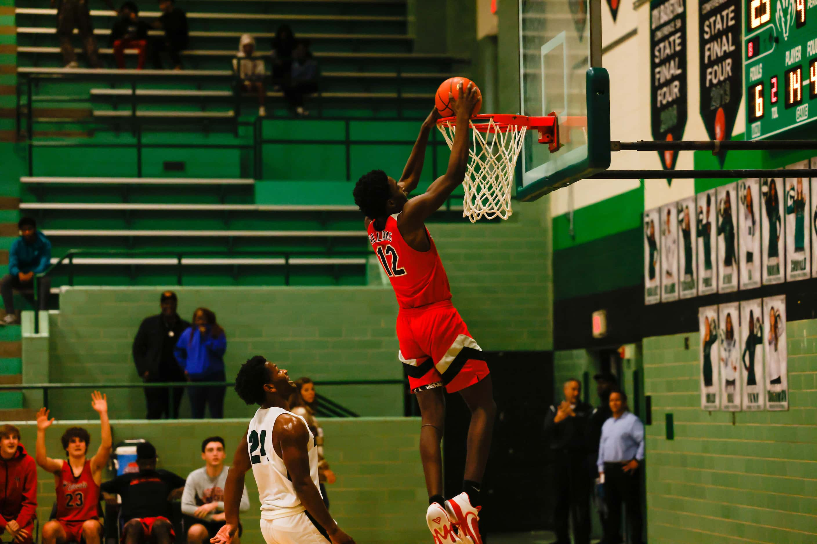 Lake Highlands High School' Jaire Williams #12 dunks the basketball during the second half...