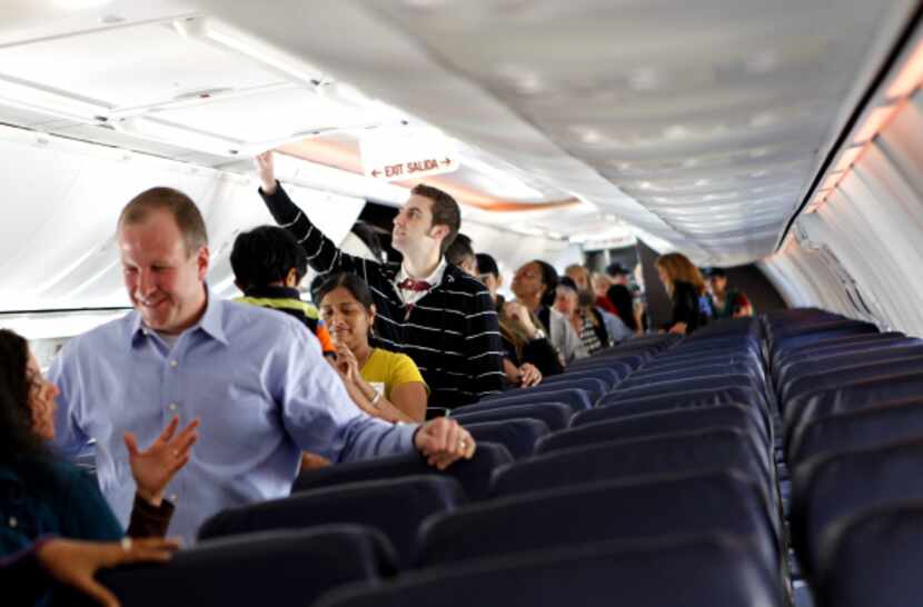 Employees tour a Boeing 737-800 at the launch party. Company officials say the larger planes...