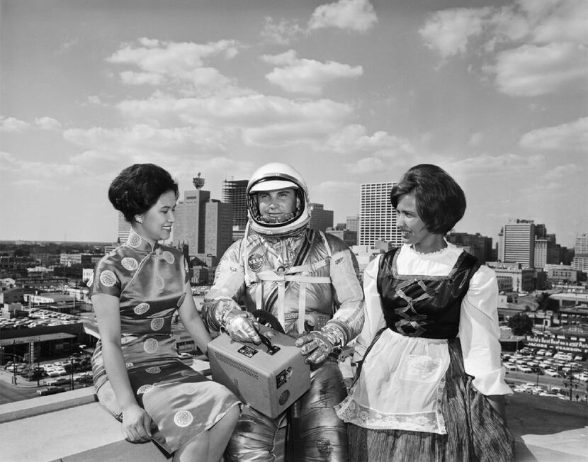 A male model dressed as an astronaut, with two women representing Houston's international...