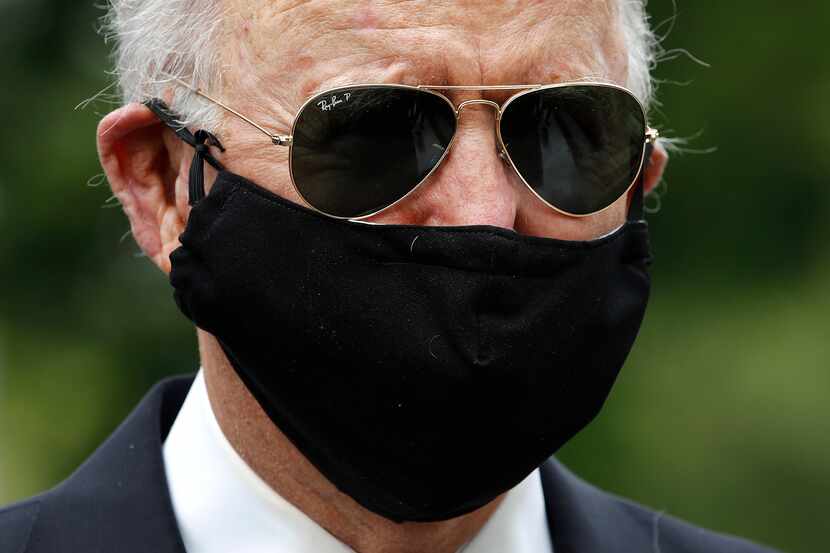In this May 25, 2020, photo former Vice President Joe Biden wears a face mask to protect...