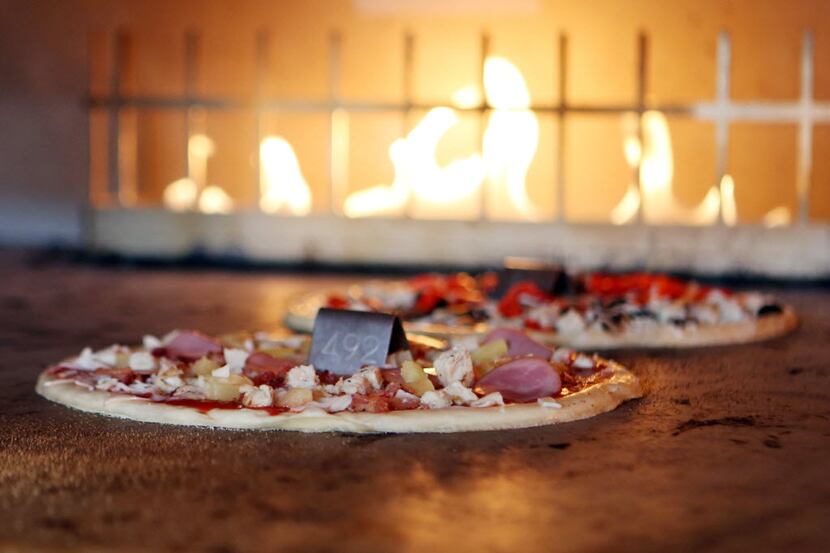 Blaze Pizza uses a hot open-flame oven to cook eleven inch thin crust pizzas, Wednesday, May...