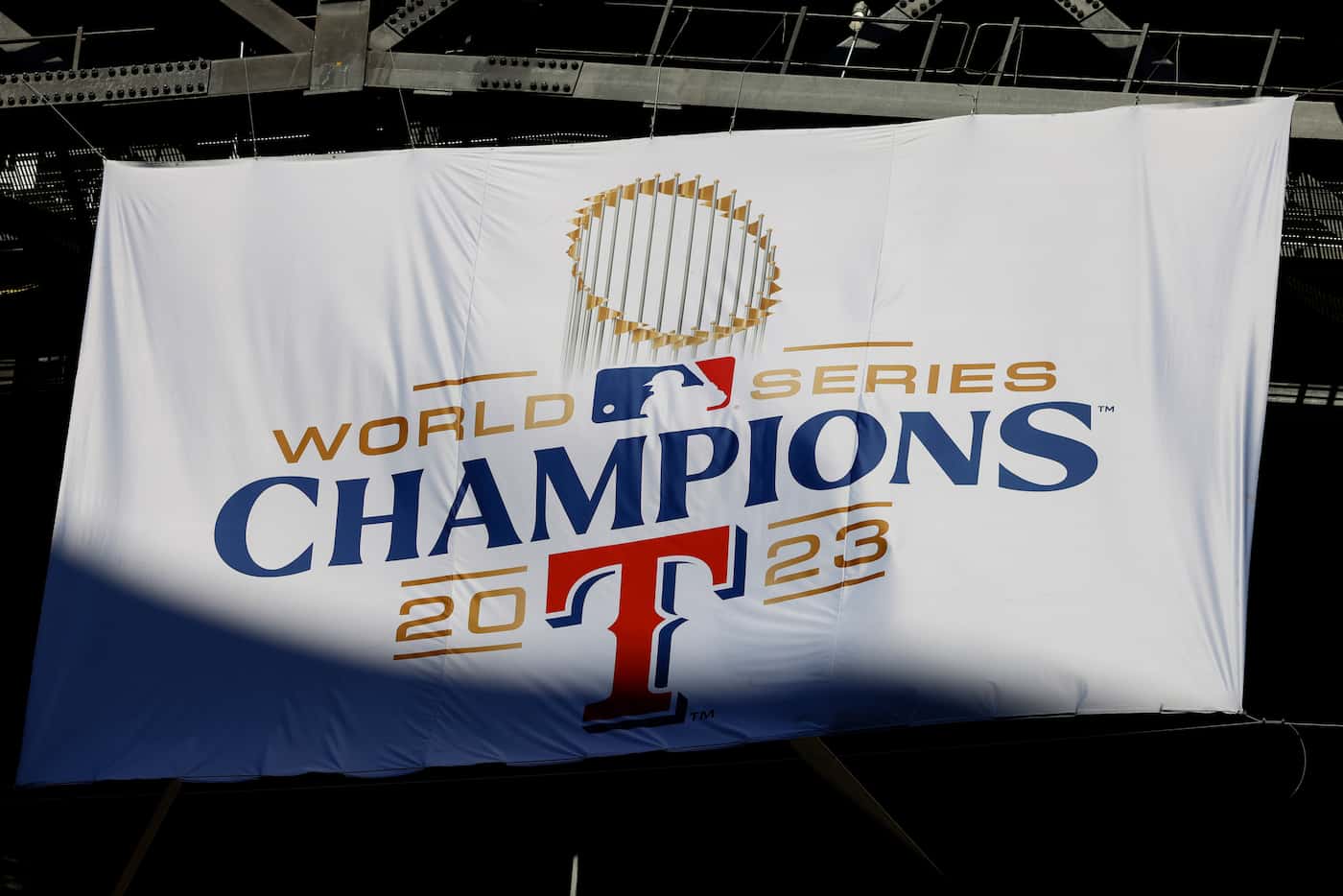 Sunlight hits the Texas Rangers World Series championship banner as the roof at Globe Life...
