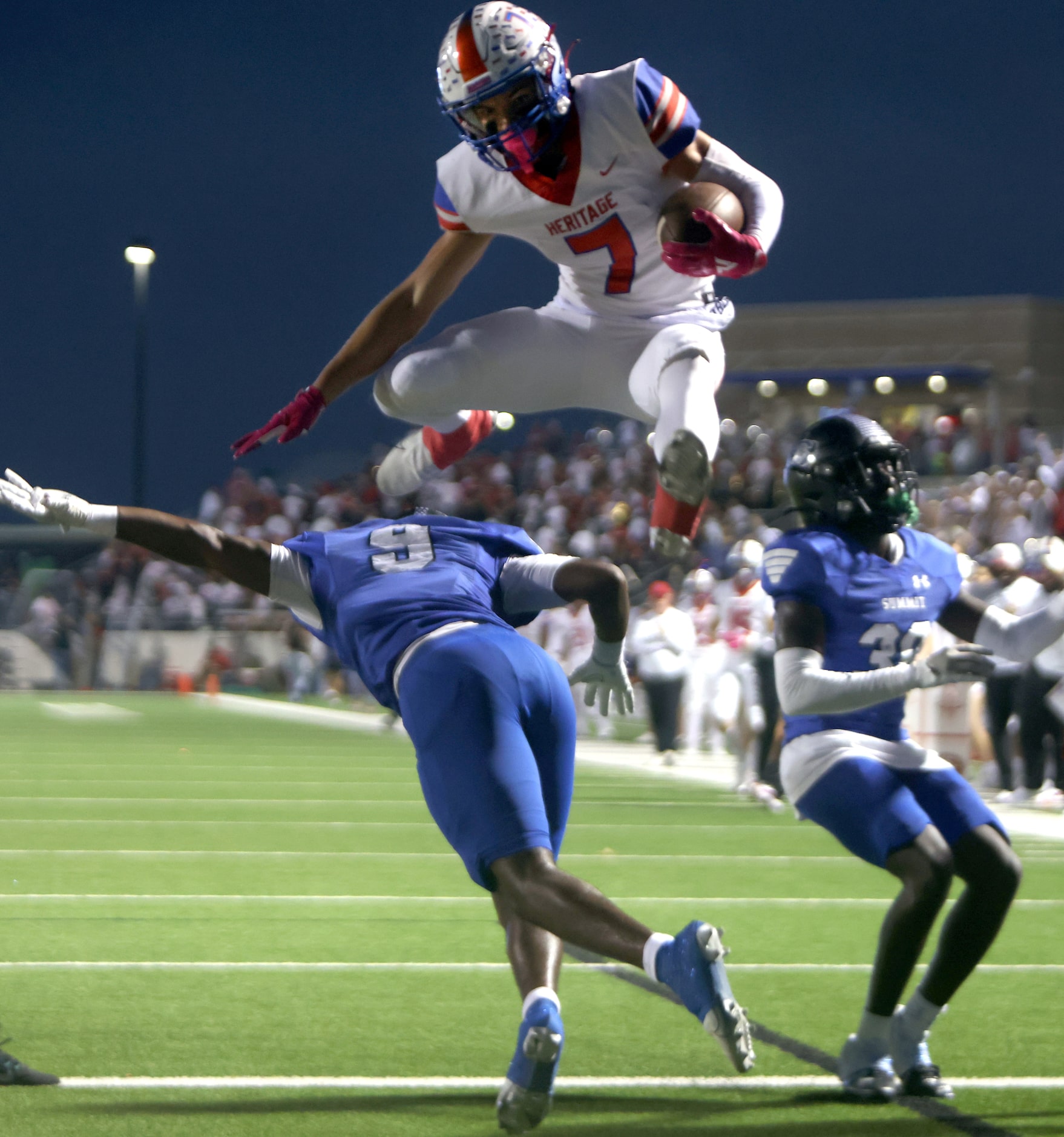 Midlothian Heritage receiver Stetson Sarratt (7) hurdles Mansfield Summit linebacker Jaden...