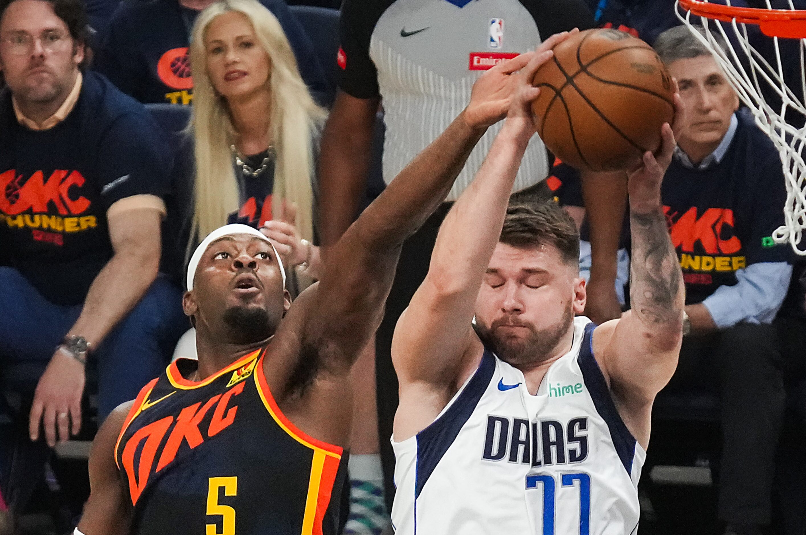 Dallas Mavericks guard Luka Doncic (77) grabs a rebound from Oklahoma City Thunder guard...