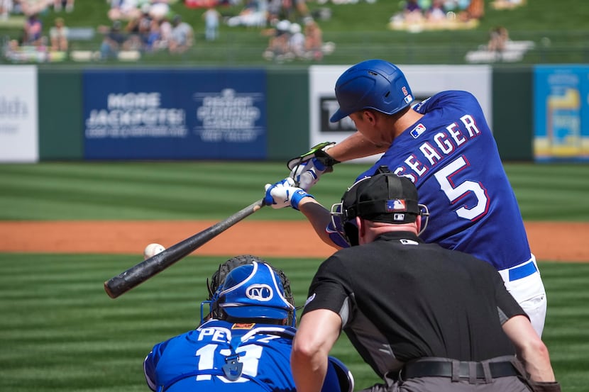 Texas Rangers infielder Corey Seager connects on a single in his first spring training game...