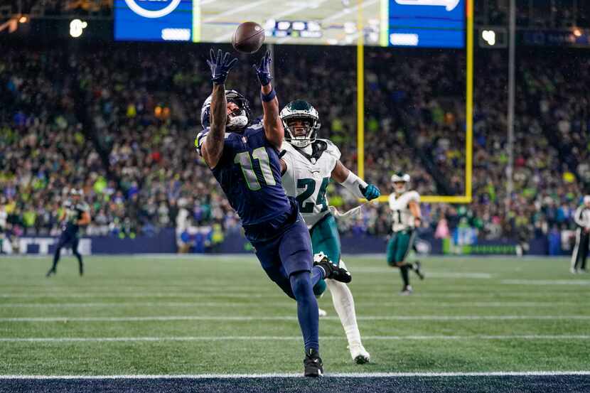 Seattle Seahawks wide receiver Jaxon Smith-Njigba (11) makes a touchdown catch in front of...