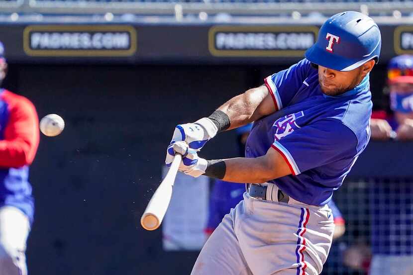 Texas Rangers outfielder Jason Martin hits a solo home run during the fifth inning of a...