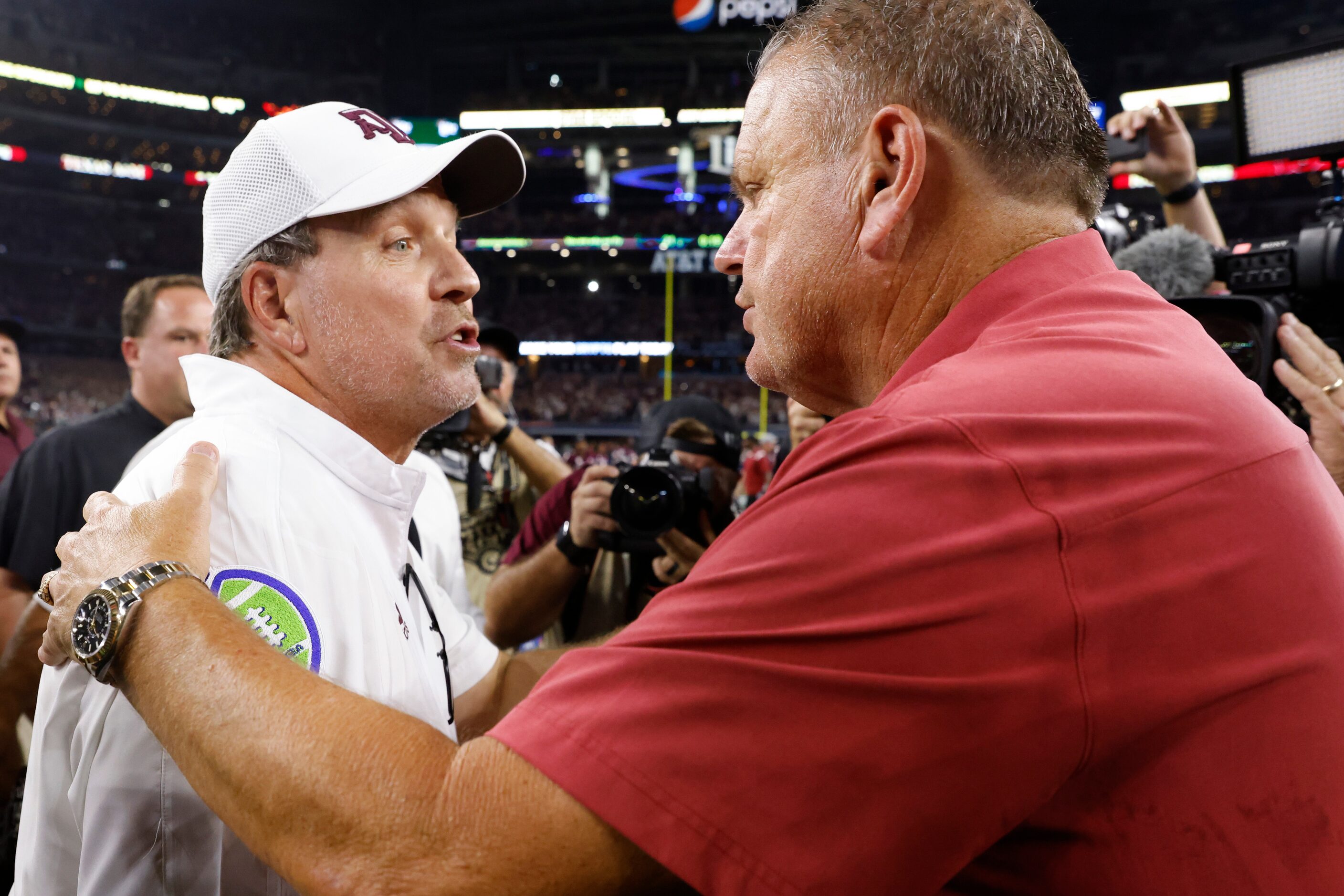 Arkansas head coach Sam Pittman, right, and Texas A&M head coach Jimbo Fisher greets each...