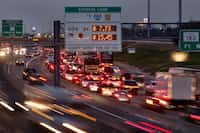 At dusk, traffic flows on the TEXpress Lanes (left) along westbound SH 183 (right) at...