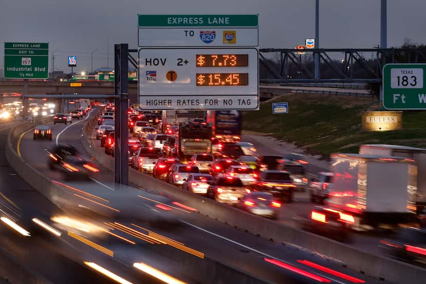 At dusk, traffic flows on the TEXpress Lanes (left) along westbound SH 183 (right) at...