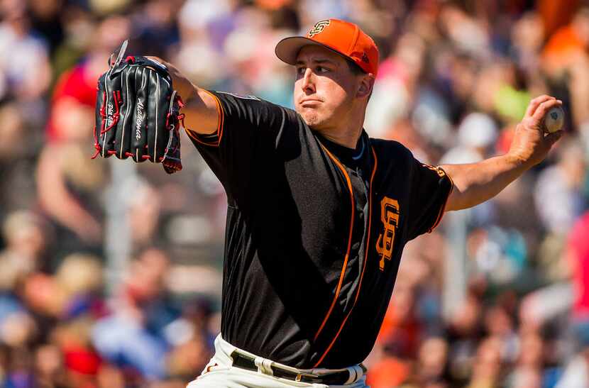 San Francisco Giants pitcher Derek Holland pitches during the third inning of a spring...