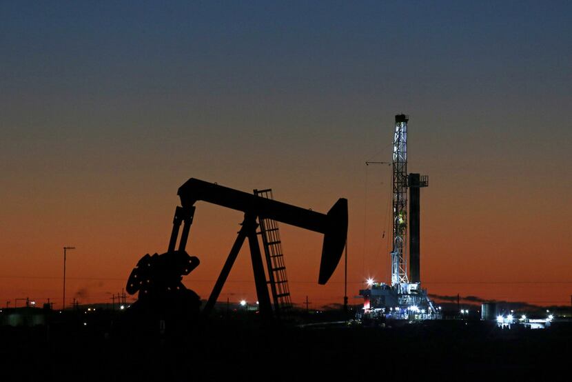 An oil rig and pump jack in Midland. Falling natural gas prices have been unkind to Texas,...