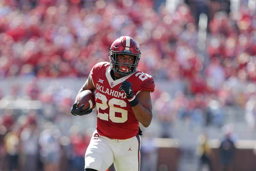 Oklahoma running back Kennedy Brooks (26) runs for a first down against West Virginia during...