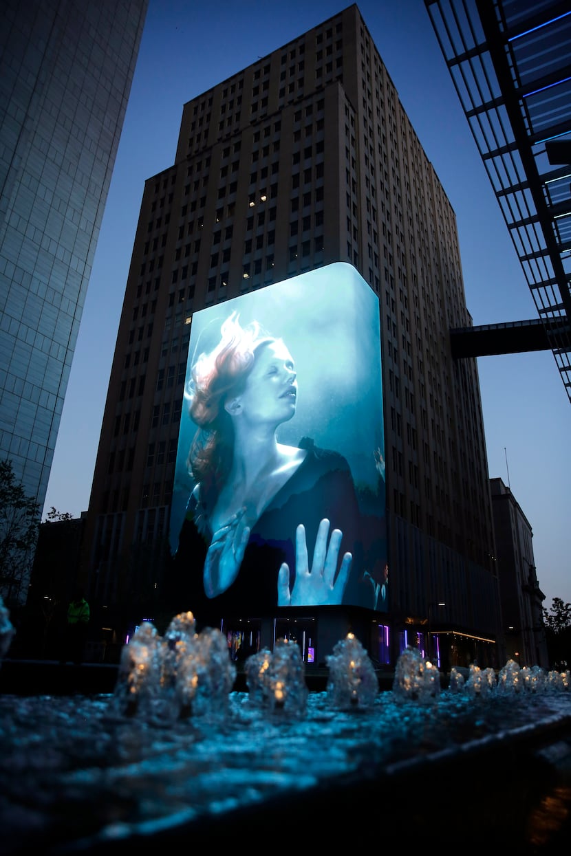 The 104-foot-tall media wall wraps around the building corner at Akard and Jackson streets...