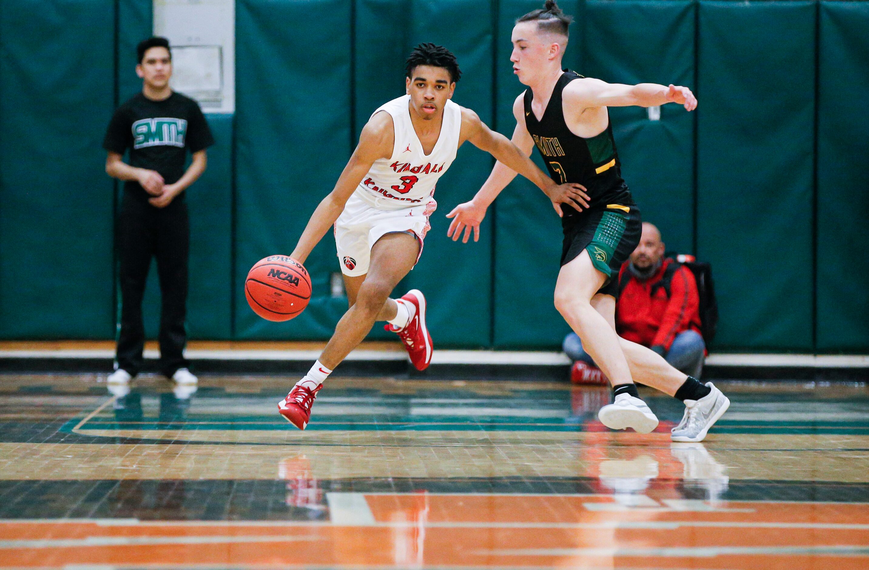 Kimball junior DJ Pigford (3) battles senior Marshal Funches (2) for space during the first...