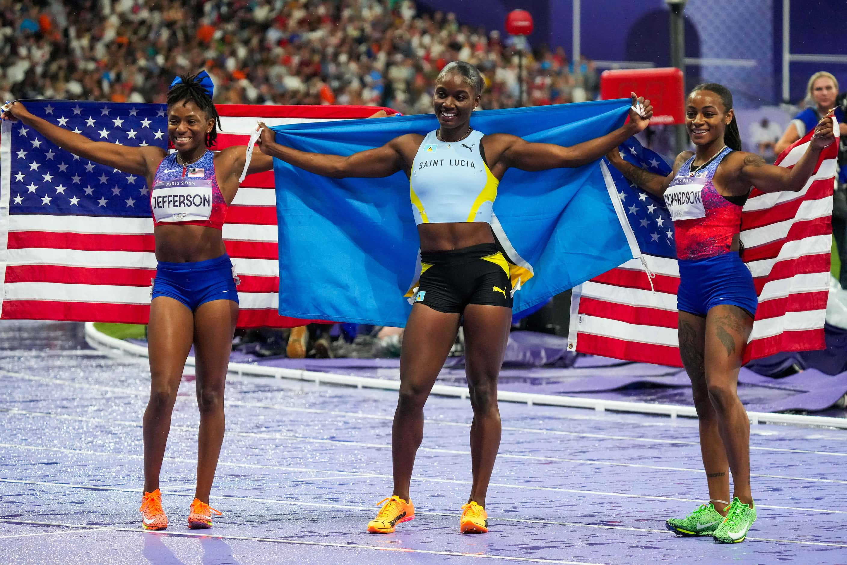 Gold medalist Julien Alfred of Saint Lucia (center) celebrates with silver medalist...