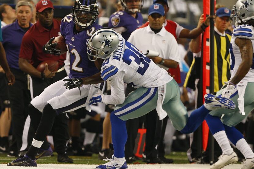 Dallas Cowboys cornerback Terrance Mitchell (30) pushes Baltimore Ravens wide receiver...