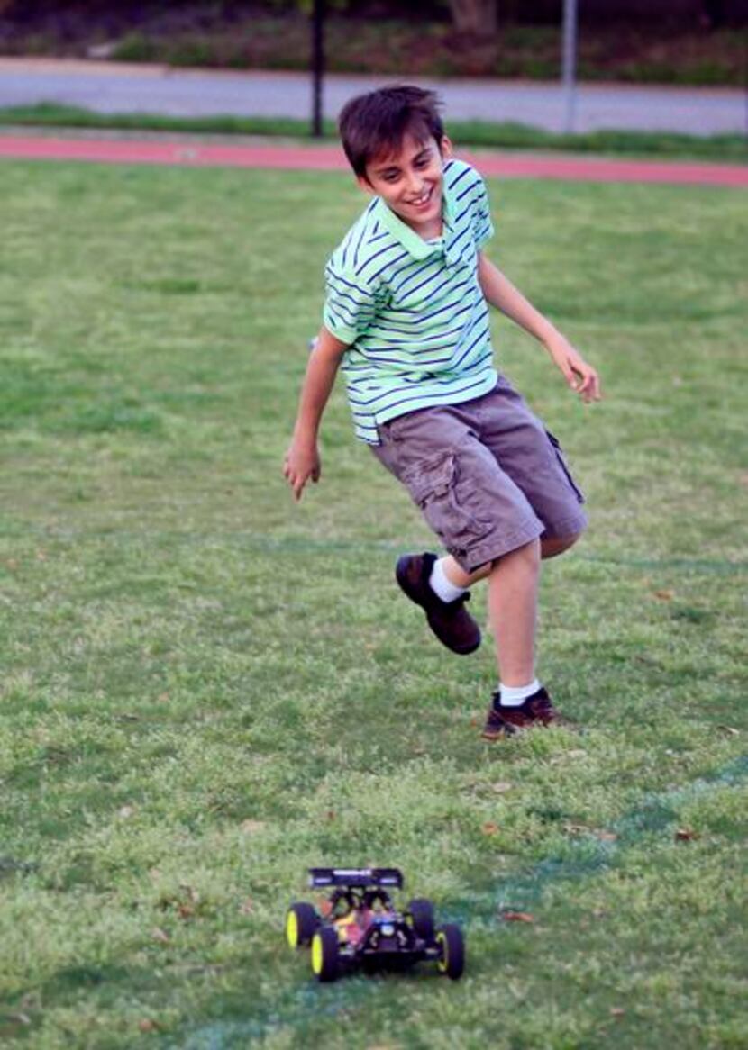 
Diego Valle, 11, runs after a radio controlled off-road vehicle while his younger sister...