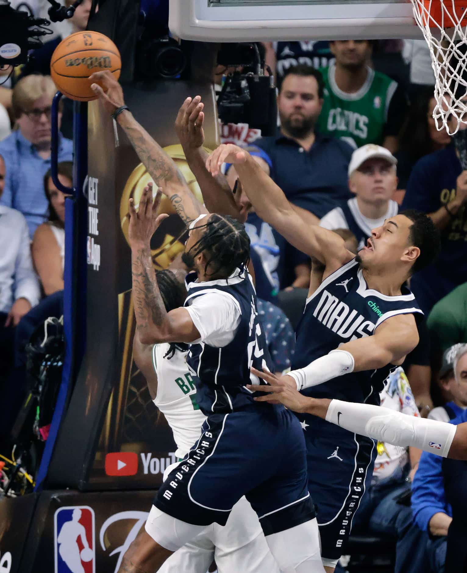 Dallas Mavericks forward Derrick Jones Jr. (55) swats a shot away from Boston Celtics guard...