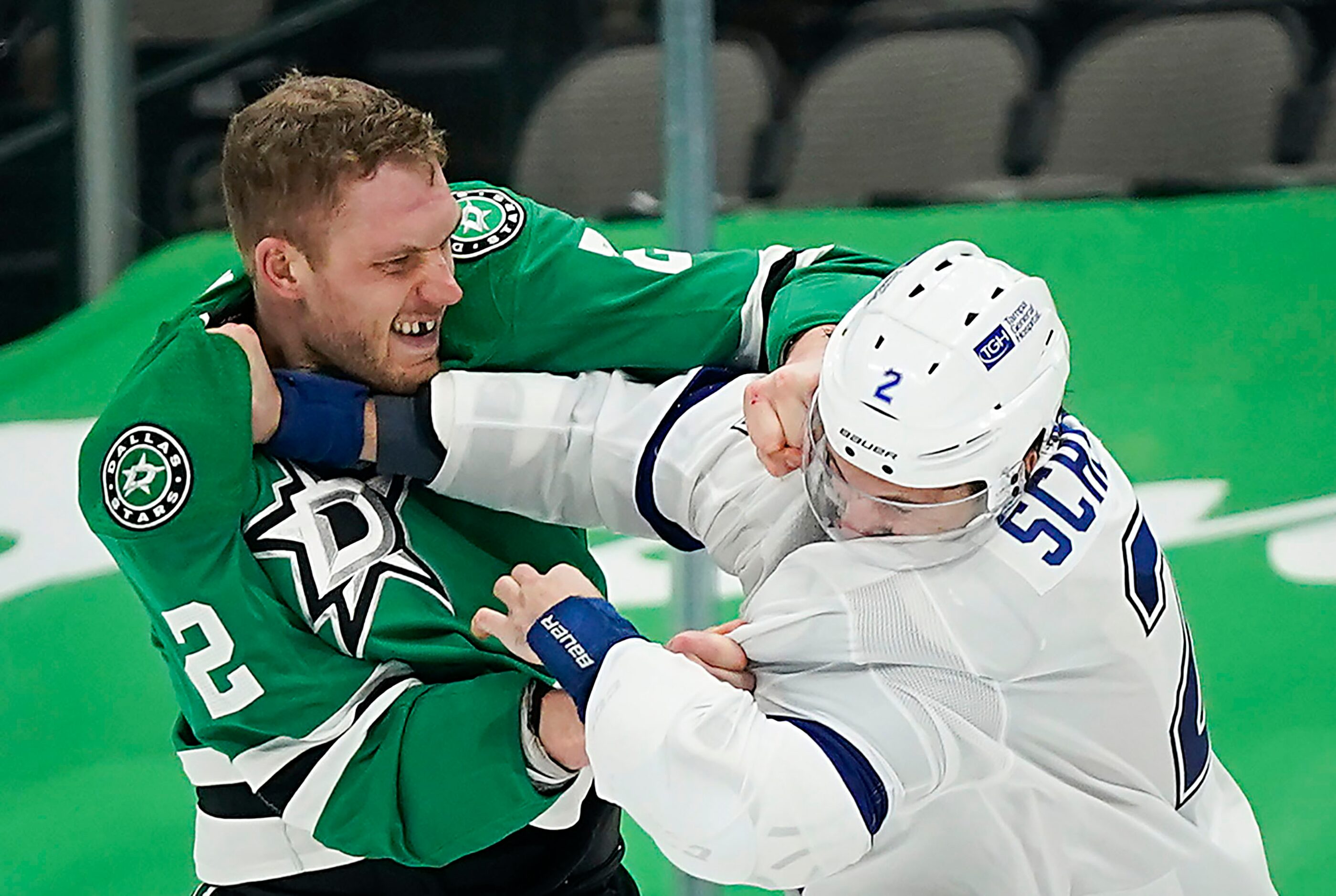 Dallas Stars defenseman Jamie Oleksiak (left) fights with Tampa Bay Lightning defenseman...