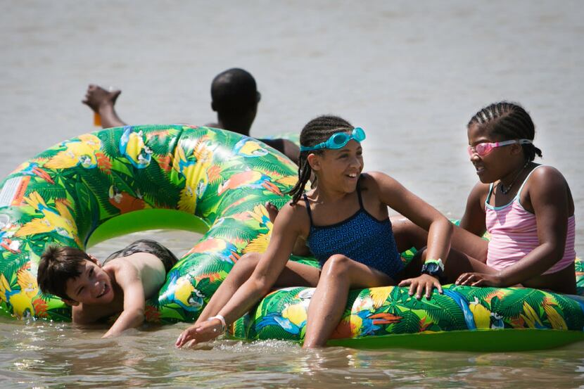 Shayla and her sister Kaylin Herron play in the water during Sunday Funday at the Panther...