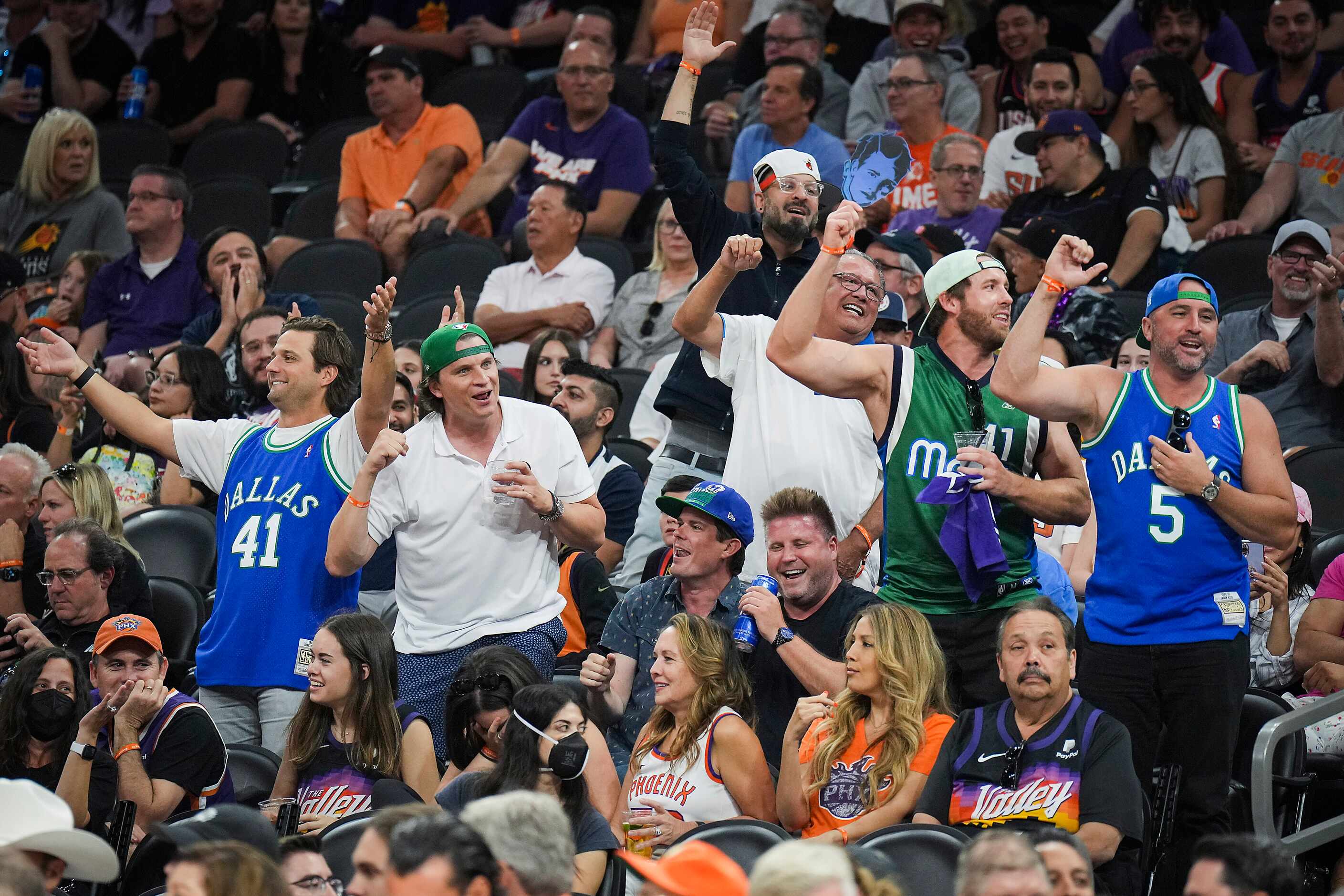 Dallas Mavericks fans cheer their team during the third quarter in Game 7 of an NBA second...