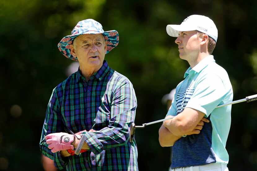 Entertainer Bill Murray and Jordan Spieth talk on the fairway of the fifth hole during the...