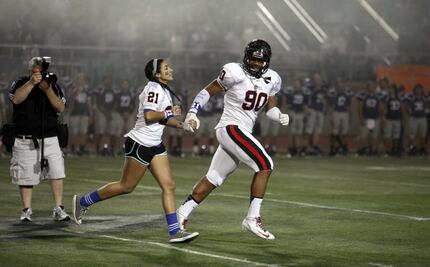 FILE - Solomon Thomas leads the sister of Jacob Logan off the field before Coppell's first...