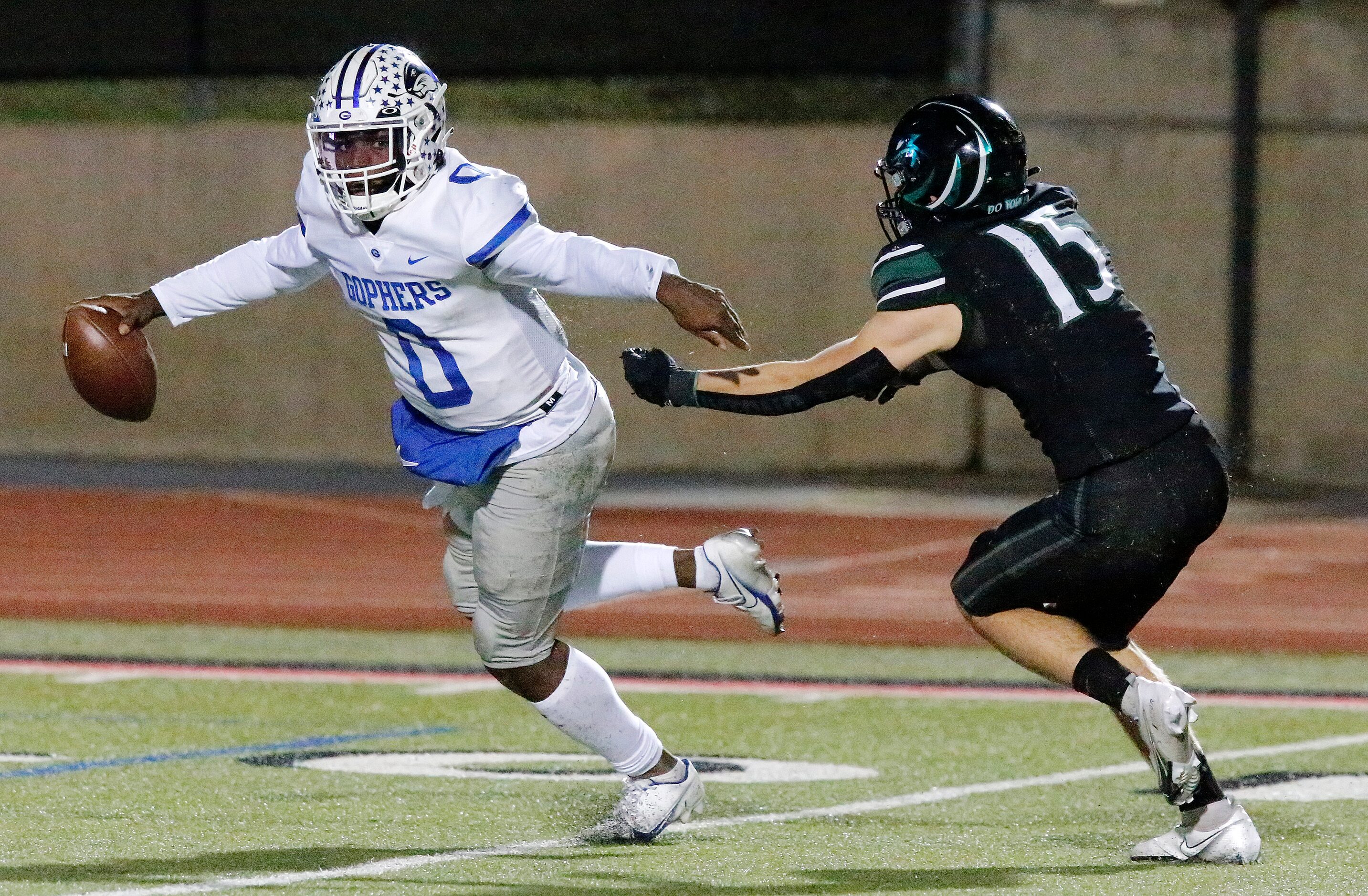 Grand Prairie High School quarterback Savion Red (0) eludes Prosper High School linebacker...