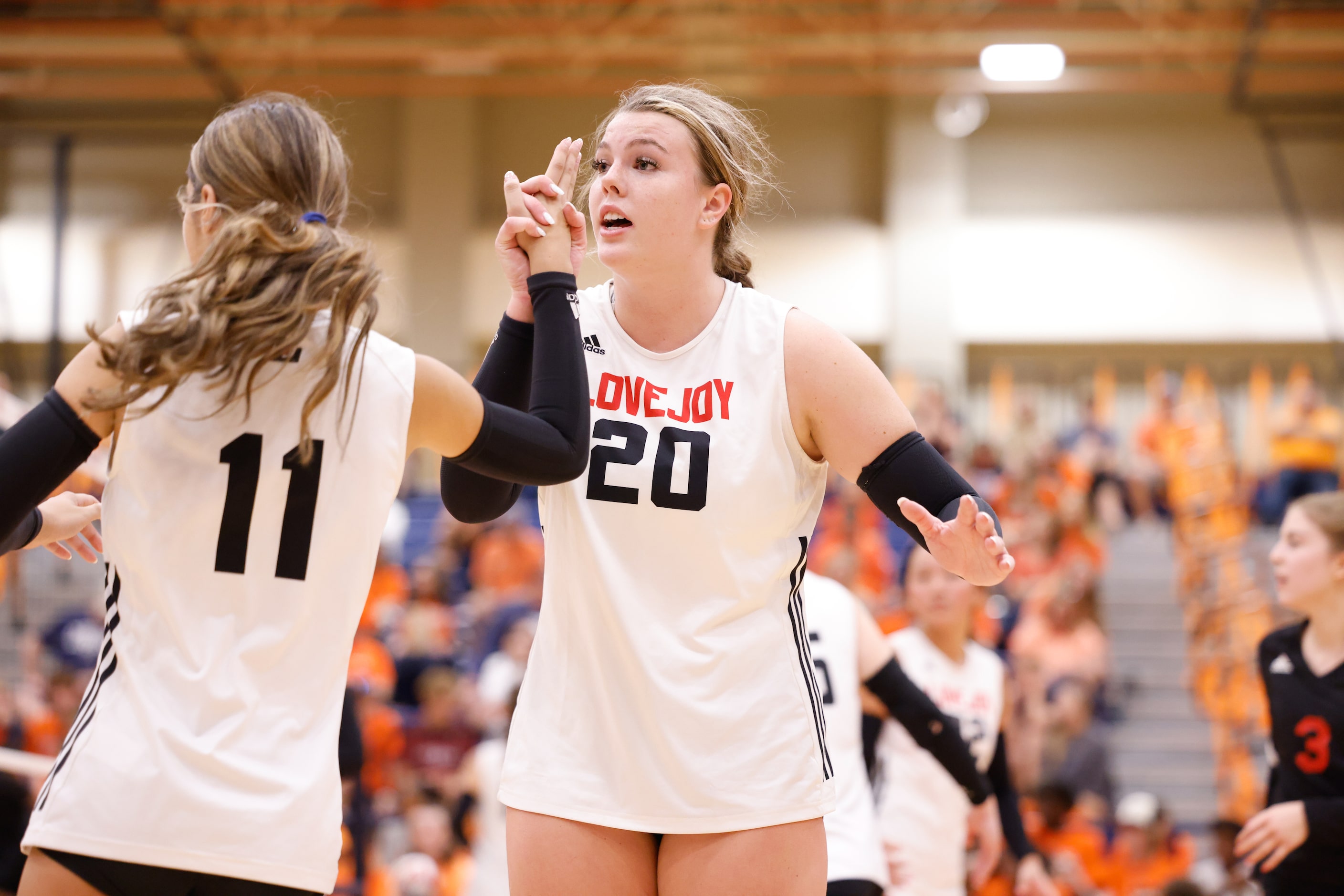 Lovejoy Reagan Fitzsimmons (20) high-fives Isa Camacho (11) after a point against McKinney...