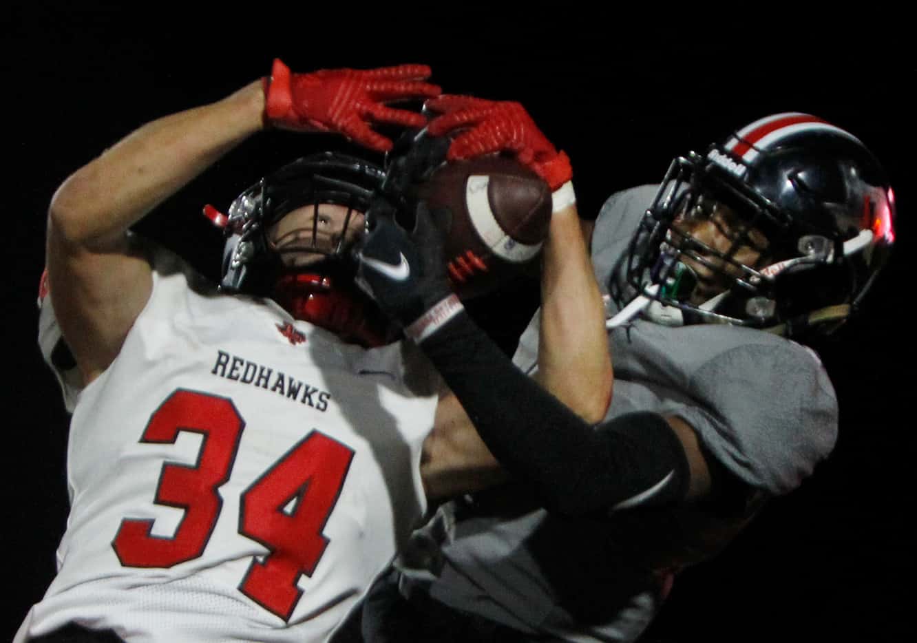 Frisco Liberty safety Sam Wenaas (34), left, wrestles an interception of a pass intended for...