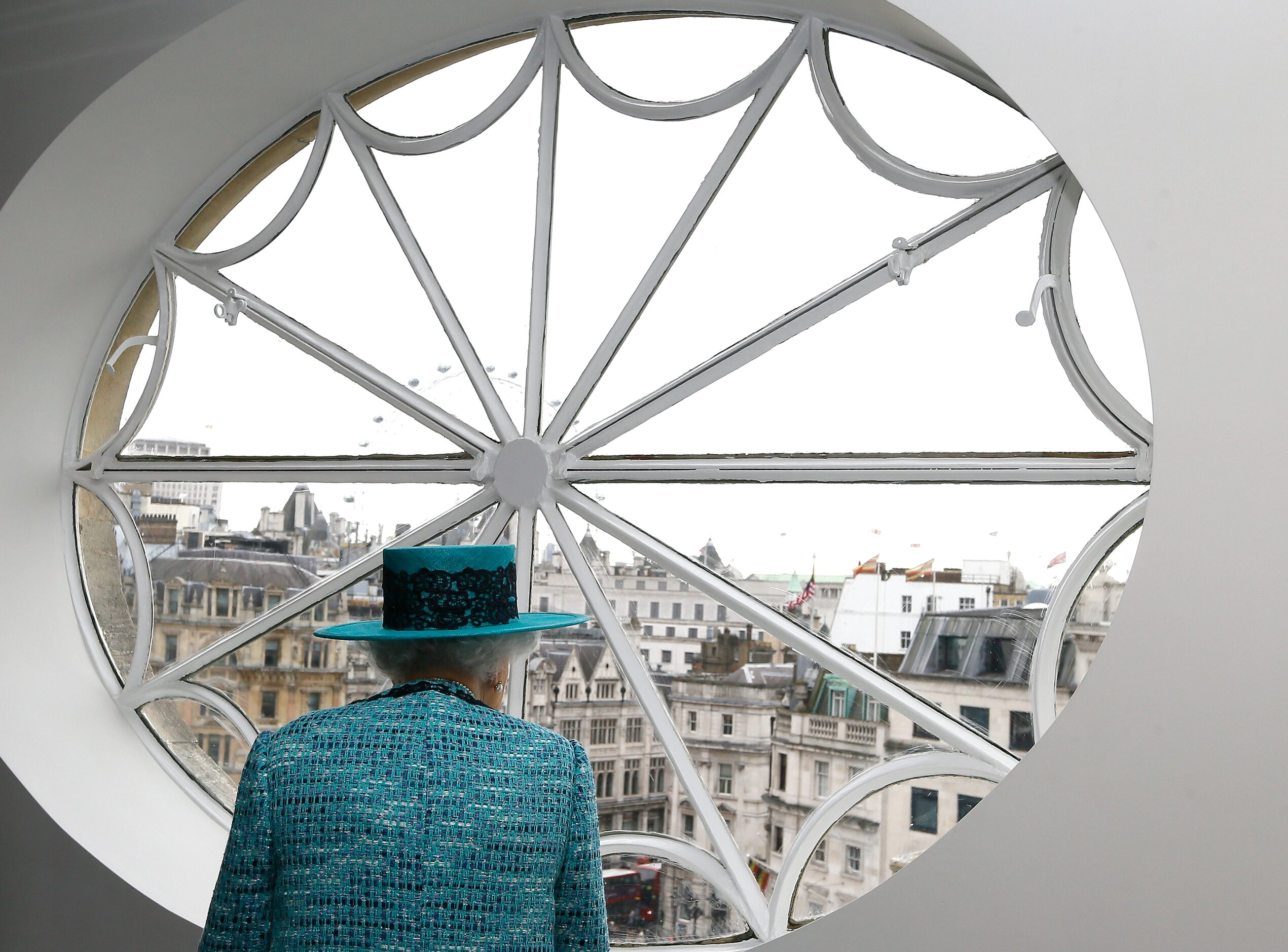 Britain's Queen Elizabeth II looks at the view out of a window, during a visit to reopen...