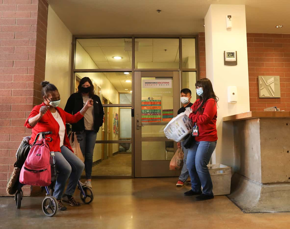 Patricia Freeman (left) dances in excitment with The Bridge Homeless Recovery Center staff...