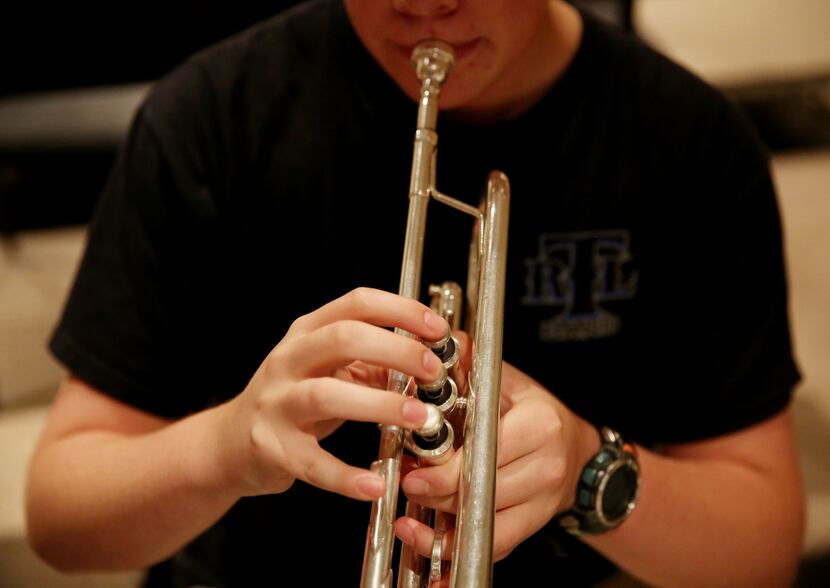 Camper Seth Bullis, 17, of Carrollton, Texas, plays the trumpet during an exercise for...