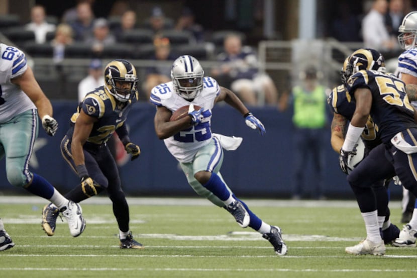 Dallas Cowboys running back Lance Dunbar (25) breaks away from St. Louis Rams strong safety...