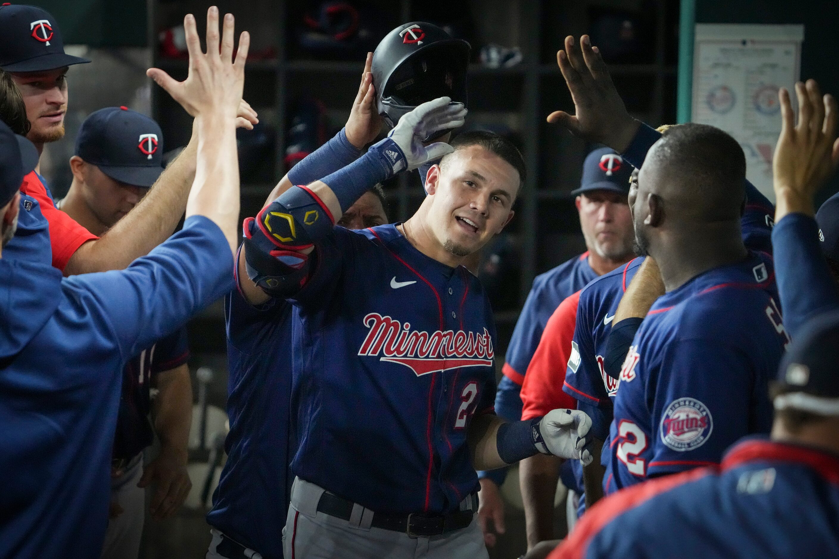 Minnesota Twins left fielder Trevor Larnach celebrates with teammates after hitting a solo...