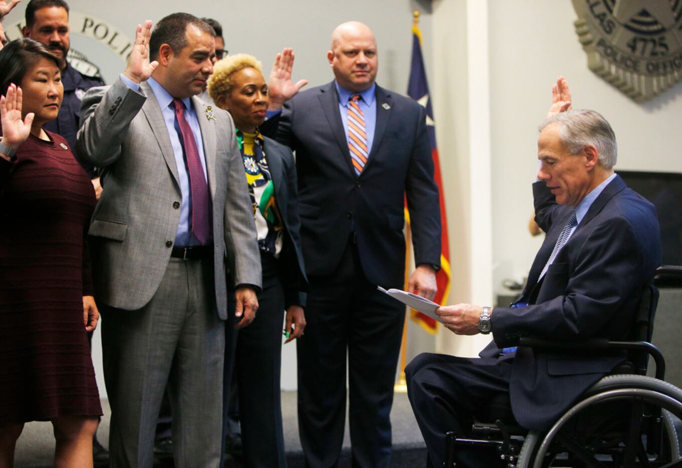 Greg Abbott swears in new board members of the Dallas Police Association before Tuesday's...