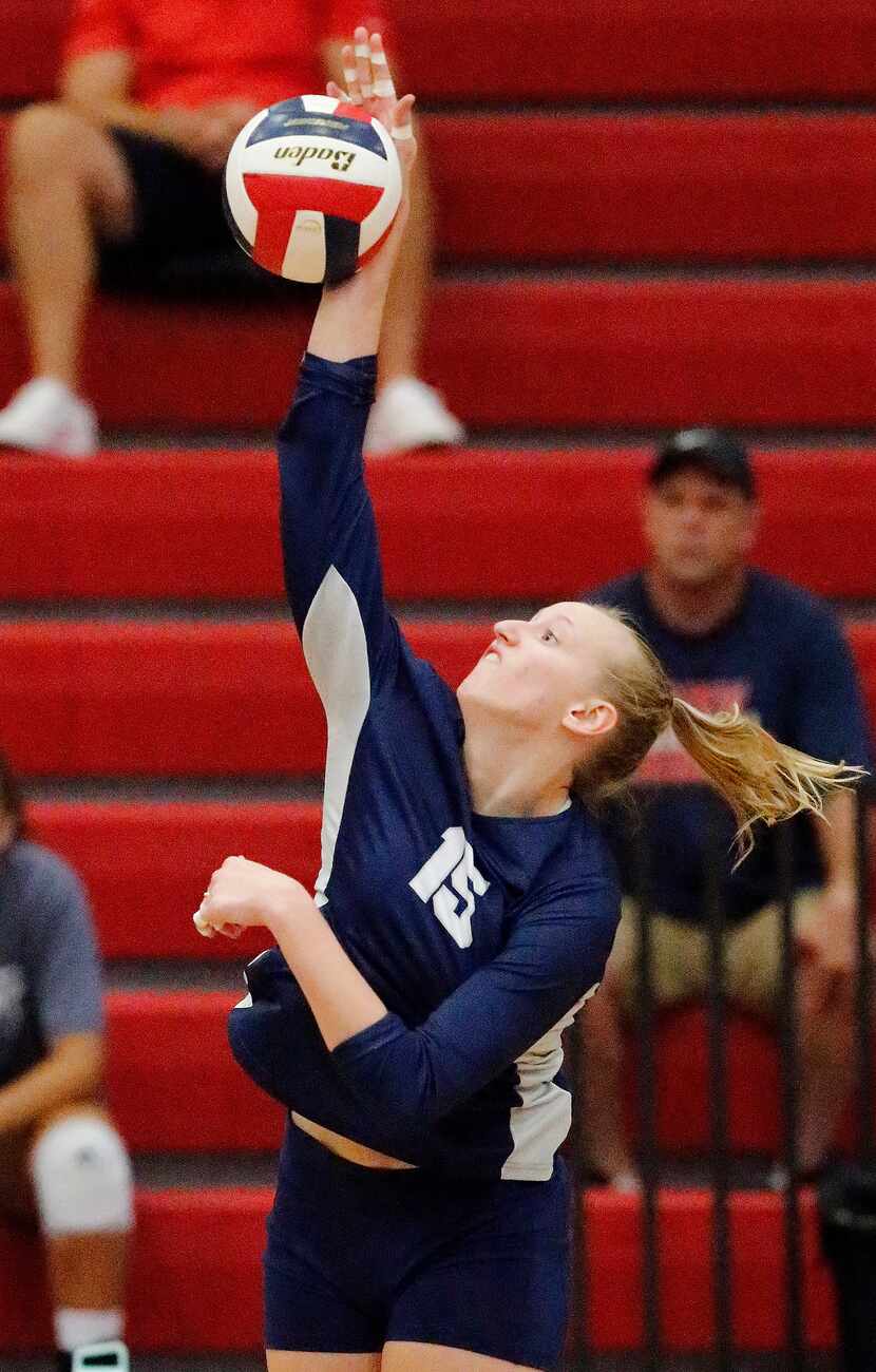 Flower Mound High School right side hitter Maddie Cox (15) gets a hit during game one as...