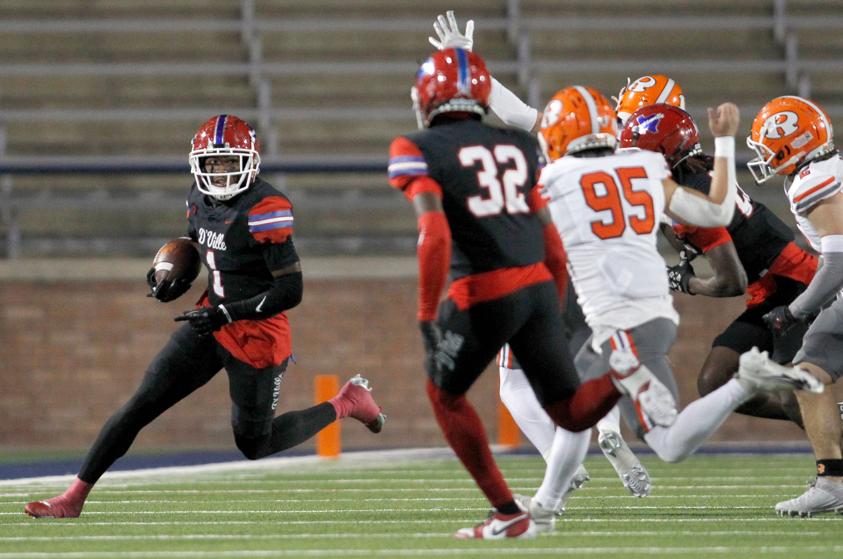 Duncanville receiver Dakorien Moore (1), left, looks for running room as he returns a punt...