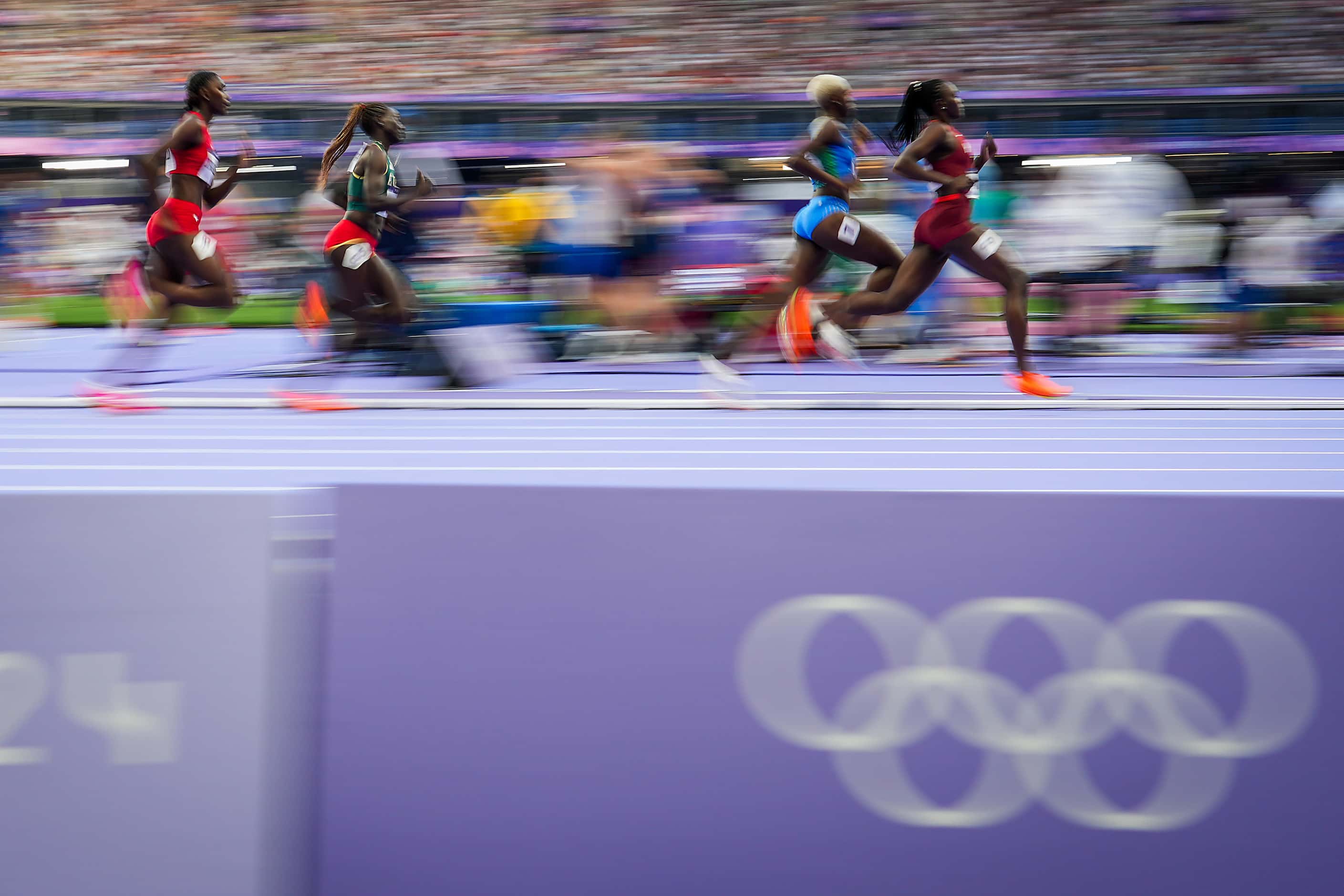 Runners round a curve in a heat of the women’s 800-meters at the 2024 Summer Olympics on...