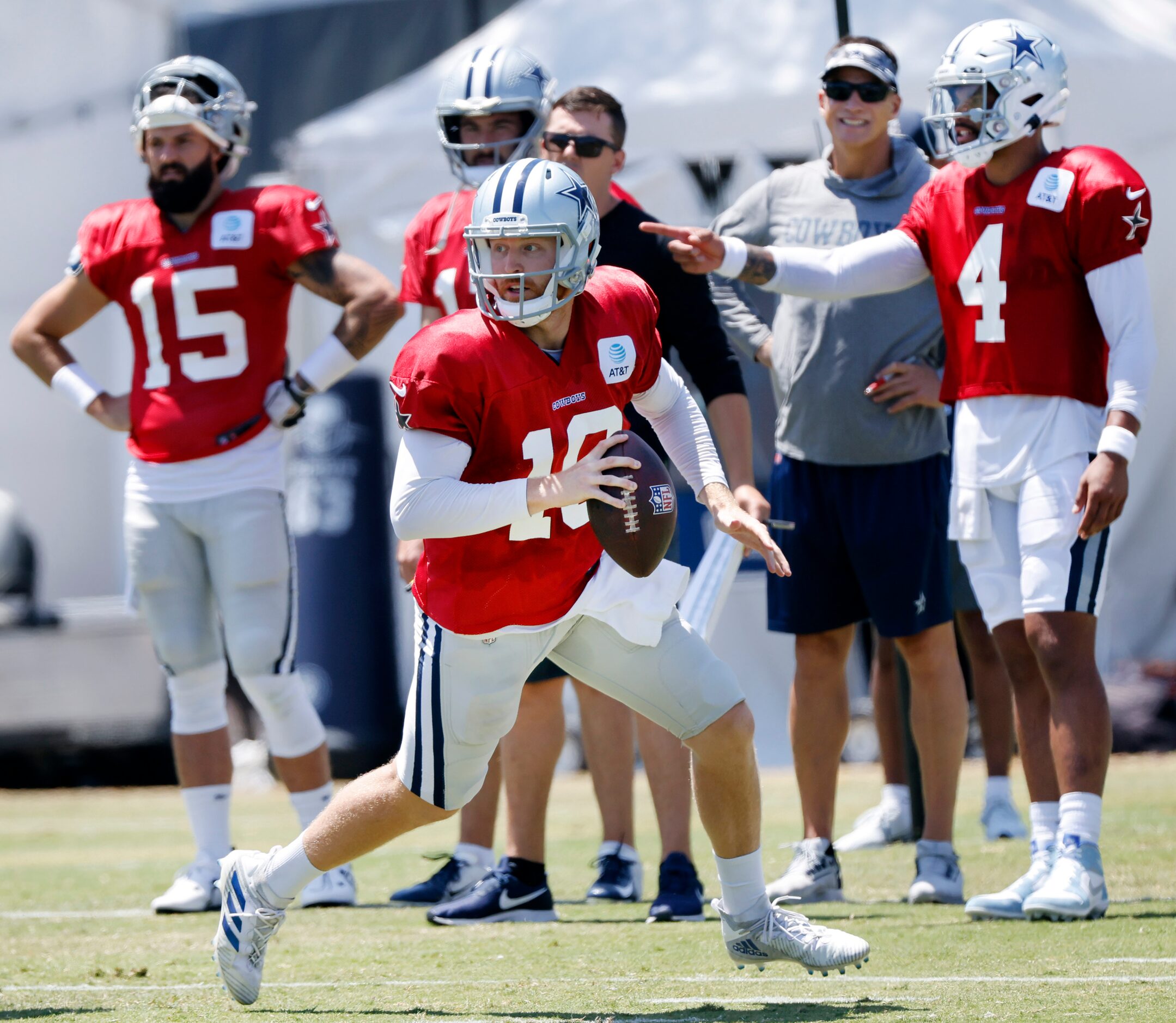 Dallas Cowboys quarterback Cooper Rush (10) rolls out looking for a receiver during 11-on-11...